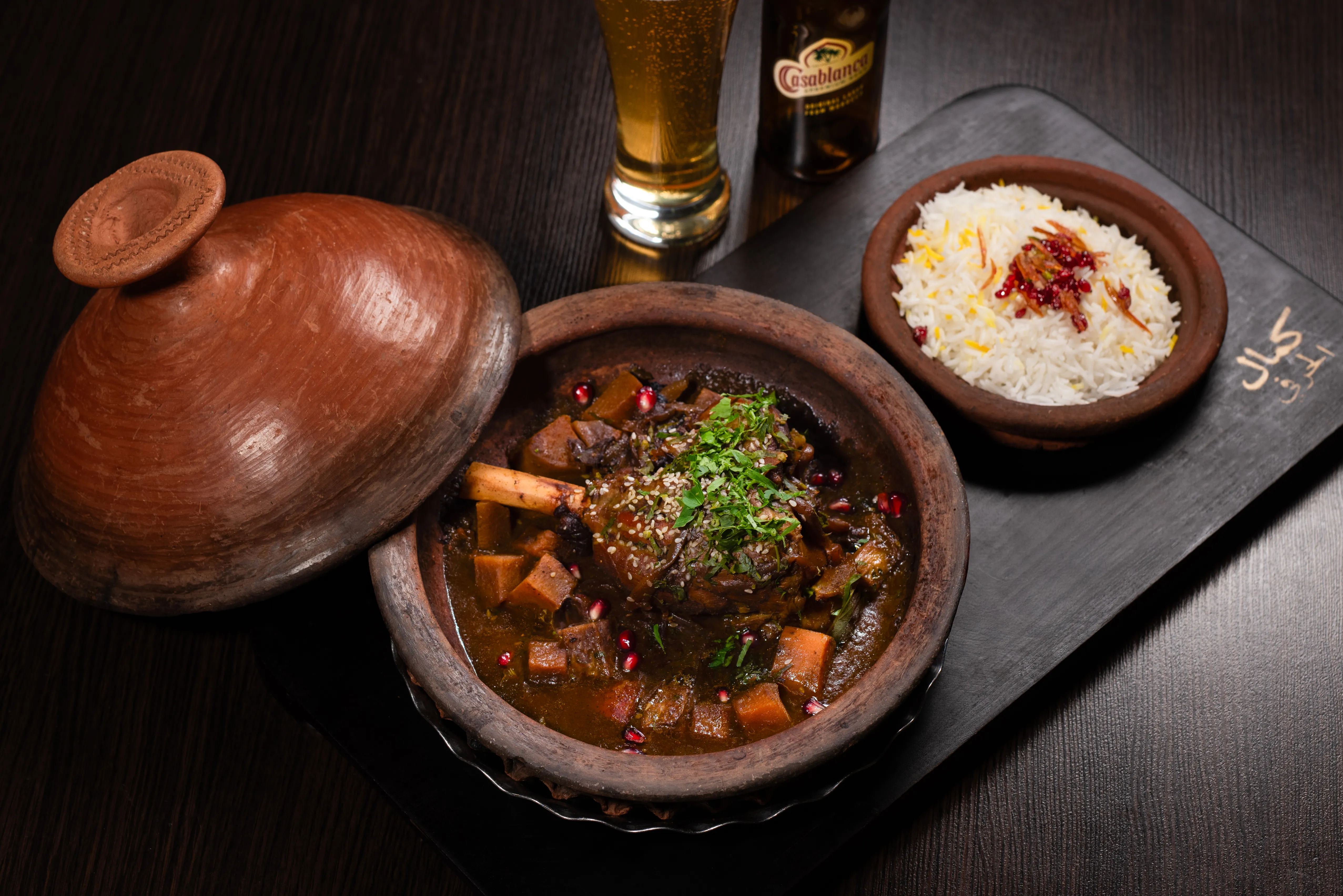 Slow-cooked lamb tagine served with Moroccan red wine